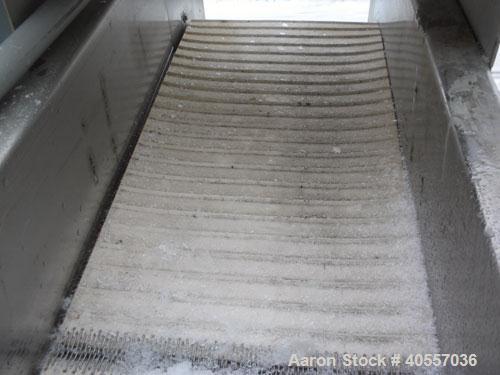 Used Incline Belt Conveyor. 12" wide x 84" long cleated rubber belt. Driven by a 1 hp, 3/60/208-230/460 volt, 1740 rpm gear motor, ratio 50 to 1. Mounted on a stainless steel frame.