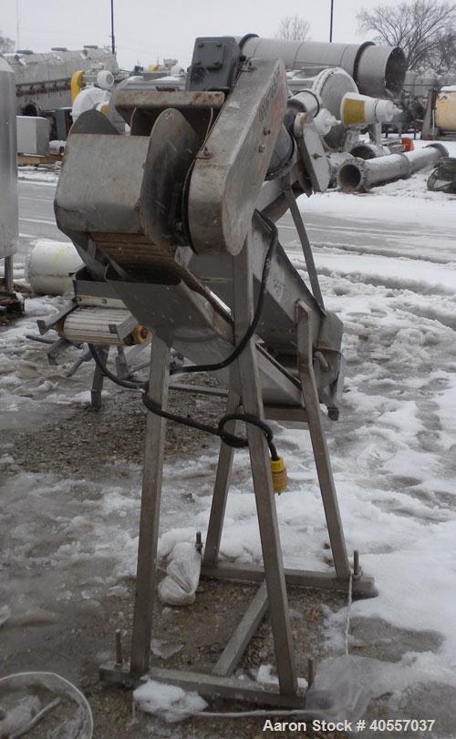 Used Incline Belt Conveyor. 6" wide x 56" long cleated rubber belt. Driven by a 3/4 hp, 3/60/208-230/460 volt, 1725 rpm gear motor, no ratio. Mounted on a stainless steel frame.