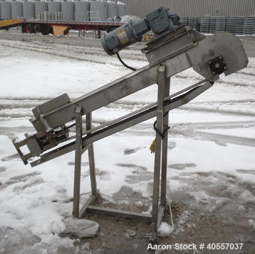 Used Incline Belt Conveyor. 6" wide x 56" long cleated rubber belt. Driven by a 3/4 hp, 3/60/208-230/460 volt, 1725 rpm gear motor, no ratio. Mounted on a stainless steel frame.
