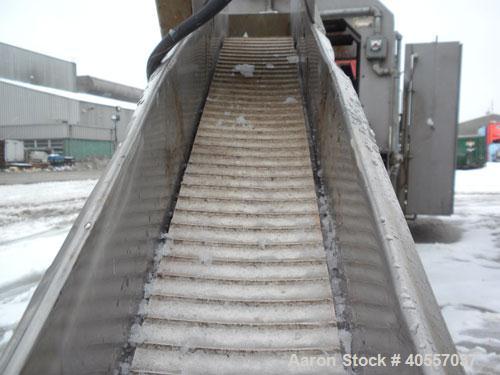 Used Incline Belt Conveyor. 6" wide x 56" long cleated rubber belt. Driven by a 3/4 hp, 3/60/208-230/460 volt, 1725 rpm gear motor, no ratio. Mounted on a stainless steel frame.