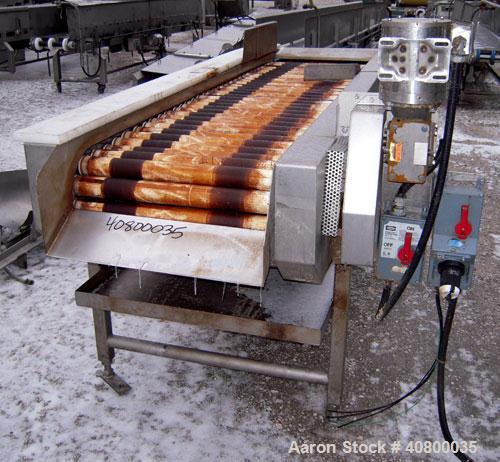Used Motorized Roller Conveyor. 24" wide x 90" long. Driven by a 1/2hp, 3/60/575 volt, 1740 rpm gear motor. Includes a bottom drip pan, mounted on a 304 stainless steel frame.