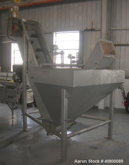 Used Inclined Plastic Belt Conveyor. 18" wide x 96" long with 9" wide x 3" tall offset pockets. 301 stainless steel supply feed hopper, 64" wide x 56" long x approximately 56" deep. Driven by an appr...