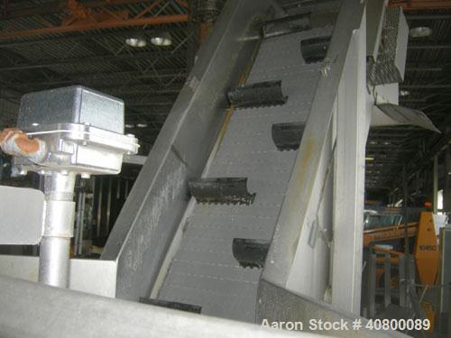 Used Inclined Plastic Belt Conveyor. 18" wide x 96" long with 9" wide x 3" tall offset pockets. 301 stainless steel supply feed hopper, 64" wide x 56" long x approximately 56" deep. Driven by an appr...