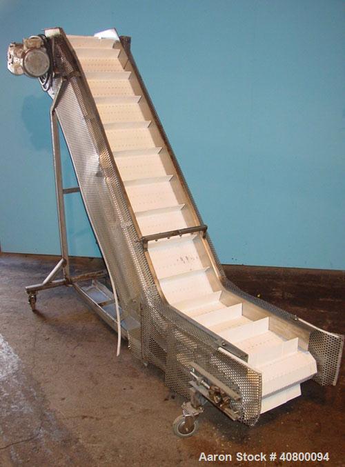 Used Inclined "S" Shaped Conveyor, 304 stainless steel frame. 14" wide x 3" tall cleated plastic belt, 24" long bottom infeed section, 72" long incline section, 12" long top discharge section, approx...