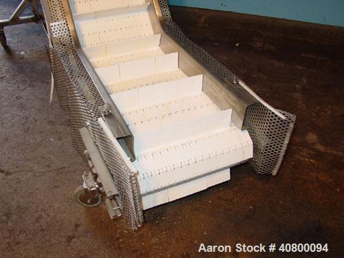Used Inclined "S" Shaped Conveyor, 304 stainless steel frame. 14" wide x 3" tall cleated plastic belt, 24" long bottom infeed section, 72" long incline section, 12" long top discharge section, approx...