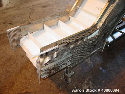 Used Inclined "S" Shaped Conveyor, 304 stainless steel frame. 14" wide x 3" tall cleated plastic belt, 24" long bottom infeed section, 72" long incline section, 12" long top discharge section, approx...