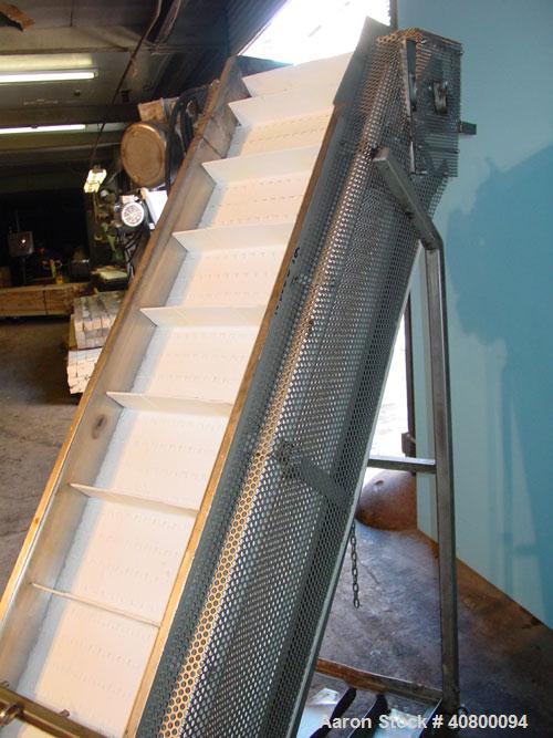 Used Inclined "S" Shaped Conveyor, 304 stainless steel frame. 14" wide x 3" tall cleated plastic belt, 24" long bottom infeed section, 72" long incline section, 12" long top discharge section, approx...