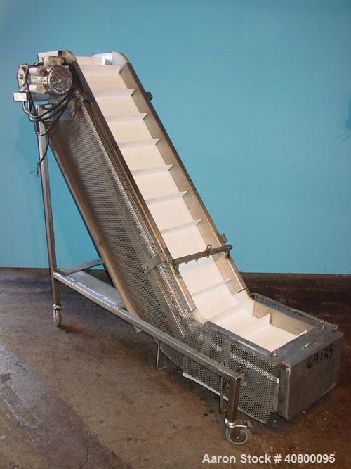 Used Inclined "S" Shaped Conveyor, 304 stainless steel frame. 12" wide x 3" tall cleated plastic belt, 24" long bottom infeed section, 72" long incline section, 12" long top discharge section, approx...