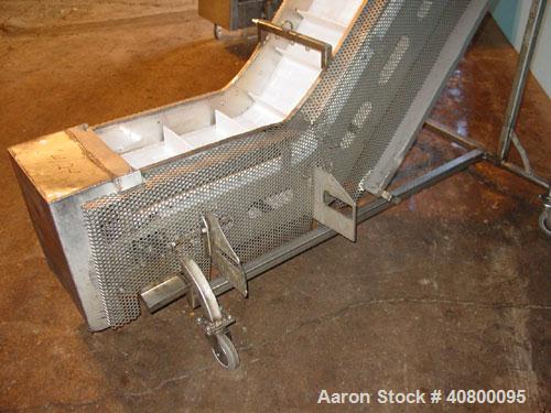 Used Inclined "S" Shaped Conveyor, 304 stainless steel frame. 12" wide x 3" tall cleated plastic belt, 24" long bottom infeed section, 72" long incline section, 12" long top discharge section, approx...