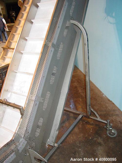 Used Inclined "S" Shaped Conveyor, 304 stainless steel frame. 12" wide x 3" tall cleated plastic belt, 24" long bottom infeed section, 72" long incline section, 12" long top discharge section, approx...