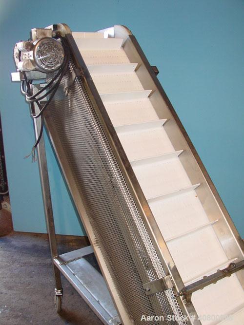 Used Trio-Pac Inclined "S" Shaped Conveyor, 304 stainless steel frame. 14" wide x 3" tall cleated plastic belt, 24" long bottom infeed section, 72" long incline section, 12" long top discharge sectio...