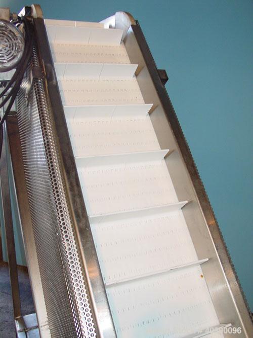 Used Trio-Pac Inclined "S" Shaped Conveyor, 304 stainless steel frame. 14" wide x 3" tall cleated plastic belt, 24" long bottom infeed section, 72" long incline section, 12" long top discharge sectio...
