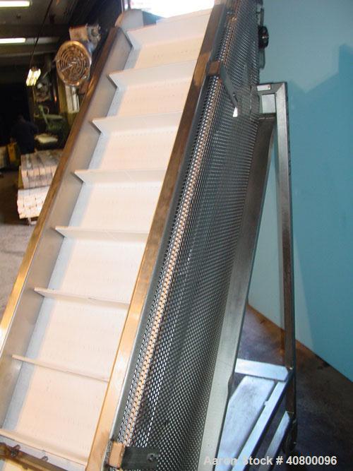 Used Trio-Pac Inclined "S" Shaped Conveyor, 304 stainless steel frame. 14" wide x 3" tall cleated plastic belt, 24" long bottom infeed section, 72" long incline section, 12" long top discharge sectio...