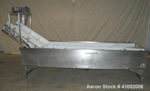 Used Inclined Plastic Submerged Belt Conveyor, 304 Stainless Steel. 24" wide x 90" long submerged section x 48" long incline section, 11 7/8" wide x 3" tall pockets. Bottom holding tank 42" wide x 12...