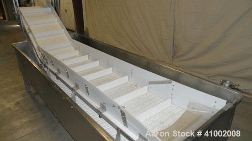 Used Inclined Plastic Submerged Belt Conveyor, 304 Stainless Steel. 24" wide x 90" long submerged section x 48" long incline section, 11 7/8" wide x 3" tall pockets. Bottom holding tank 42" wide x 12...