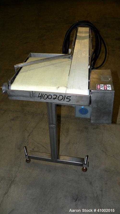 Used Belt Conveyor, Transfer Type. 4" wide x 42" long section, and a 10 3/4" wide x 14" long transfer section. Driven by a 3/4 HP, 3/60/230/460 Volt, 1750 RPM gearmotor, ratio 20 to 1. Mounted on a s...