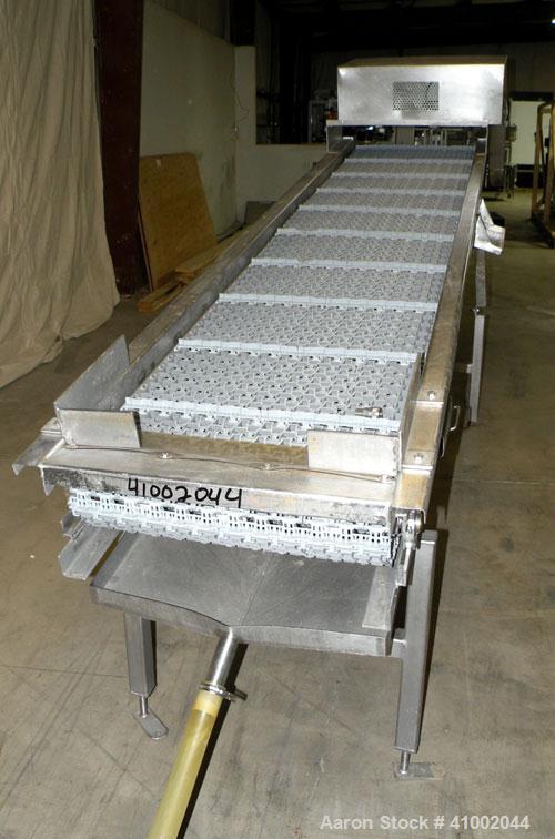 Used Ron Bichel Inclined Plastic Belt Conveyor. 24" wide x 116" long with 11 1/2" wide x 1/2" tall pockets. Driven by a 3/4 hp, 3/60/208-230/460 volt, 1750 rpm motor thru a reducer, ratio 20 to 1. 54...