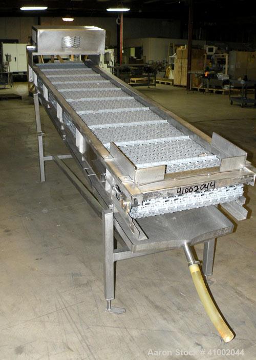 Used Ron Bichel Inclined Plastic Belt Conveyor. 24" wide x 116" long with 11 1/2" wide x 1/2" tall pockets. Driven by a 3/4 hp, 3/60/208-230/460 volt, 1750 rpm motor thru a reducer, ratio 20 to 1. 54...
