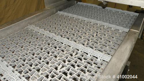 Used Ron Bichel Inclined Plastic Belt Conveyor. 24" wide x 116" long with 11 1/2" wide x 1/2" tall pockets. Driven by a 3/4 hp, 3/60/208-230/460 volt, 1750 rpm motor thru a reducer, ratio 20 to 1. 54...