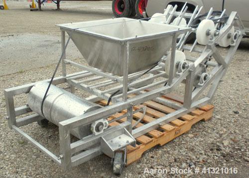 Used Inclined "S" Shaped Belt Conveyor. Approximate 24" wide rubber belt with 17" wide x 10" long x 3" deep pockets. Approximate 48" long bottom section with 27" x 27" feed hopper x 156" long incline...