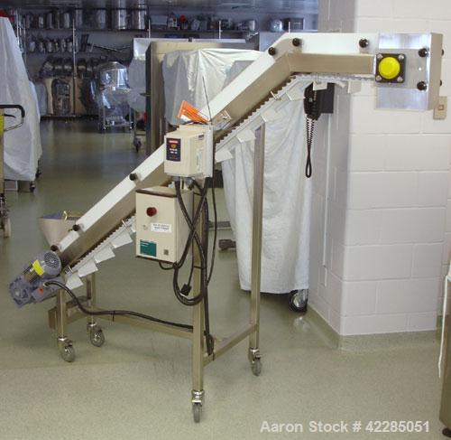 Used Inclined Tablet Elevator/Conveyor, 6" Wide Cleated Belt. 2" High cleats, 62" discharge height. Mounted on a stainless steel frame. Includes motor and VFD. Price includes 15% buyer's premium. Not...