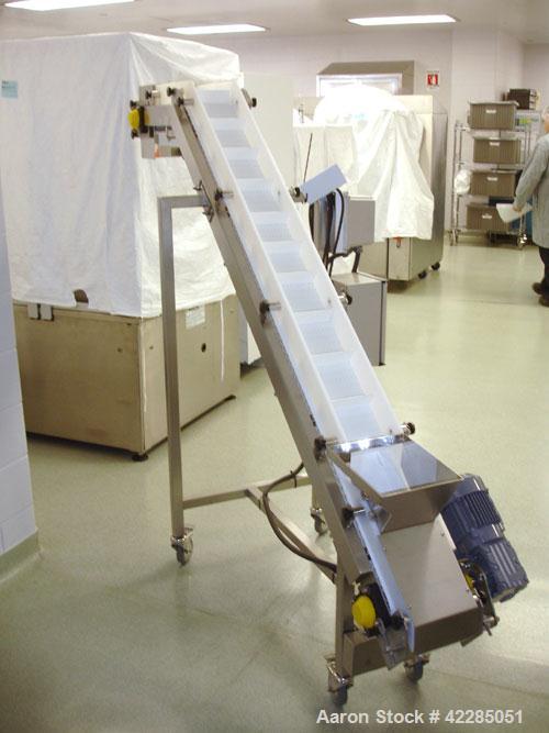 Used Inclined Tablet Elevator/Conveyor, 6" Wide Cleated Belt. 2" High cleats, 62" discharge height. Mounted on a stainless steel frame. Includes motor and VFD. Price includes 15% buyer's premium. Not...
