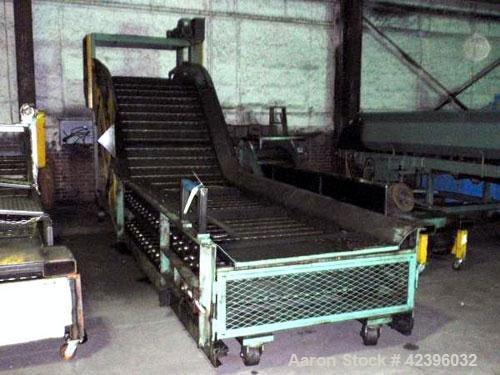 Used Z Style Metal Cleated Belt Conveyor. 46" Wide x 9' long flat section, 7' long inclined section, 4’ flat section. Approximate 84" high discharge height. With motor.