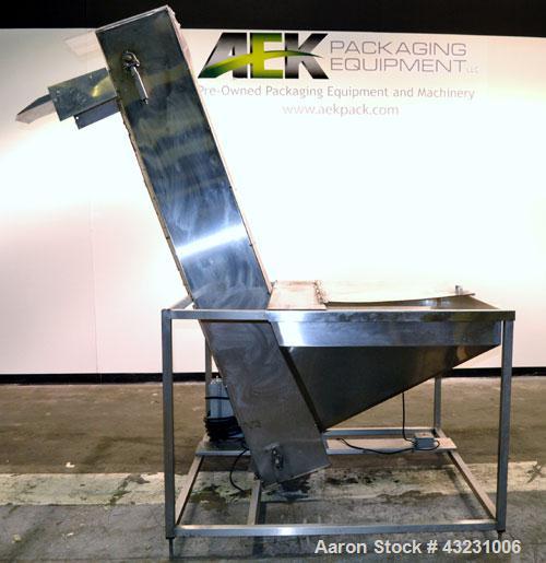 Used Bulk Elevator Feeder, Stainless Steel. Approximate 10" wide x 84 long pleated belt, approximate 80" discharge height. 56 x 42 x 24 Deep bulk supply hopper. Driven by a 1/4 hp, 90 volt DC gear mo...
