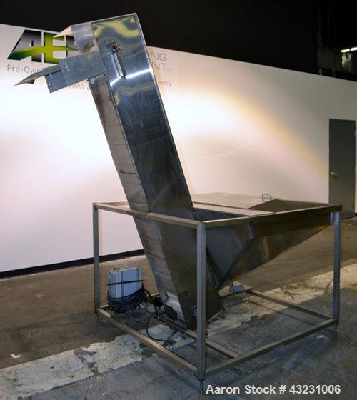 Used Bulk Elevator Feeder, Stainless Steel. Approximate 10" wide x 84 long pleated belt, approximate 80" discharge height. 56 x 42 x 24 Deep bulk supply hopper. Driven by a 1/4 hp, 90 volt DC gear mo...