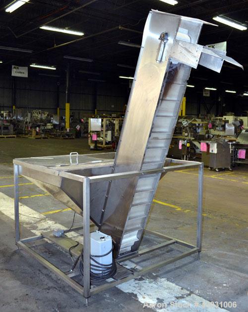 Used Bulk Elevator Feeder, Stainless Steel. Approximate 10" wide x 84 long pleated belt, approximate 80" discharge height. 56 x 42 x 24 Deep bulk supply hopper. Driven by a 1/4 hp, 90 volt DC gear mo...