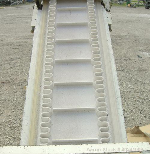 Used Rapat Corp "S" shaped flexwall incline conveyor, model FLX21.516. Carbon steel frame, approximately 12" wide cleated rubber belt, 1" tall accordion sides, 51" long top infeed section, 12' long i...