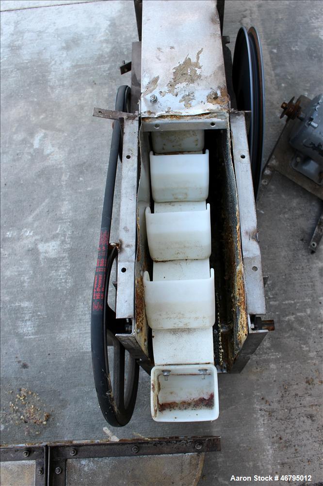 Used Bucket Elevator, Vertical. Approximate 12' Tall housing with 3-1/4" long x 4" wide x 3" deep poly buckets on 5-1/2" centers. Driven by a 0.5hp, 3/60/208-230/460 volt, 1725 rpm motor. 304 Stainle...
