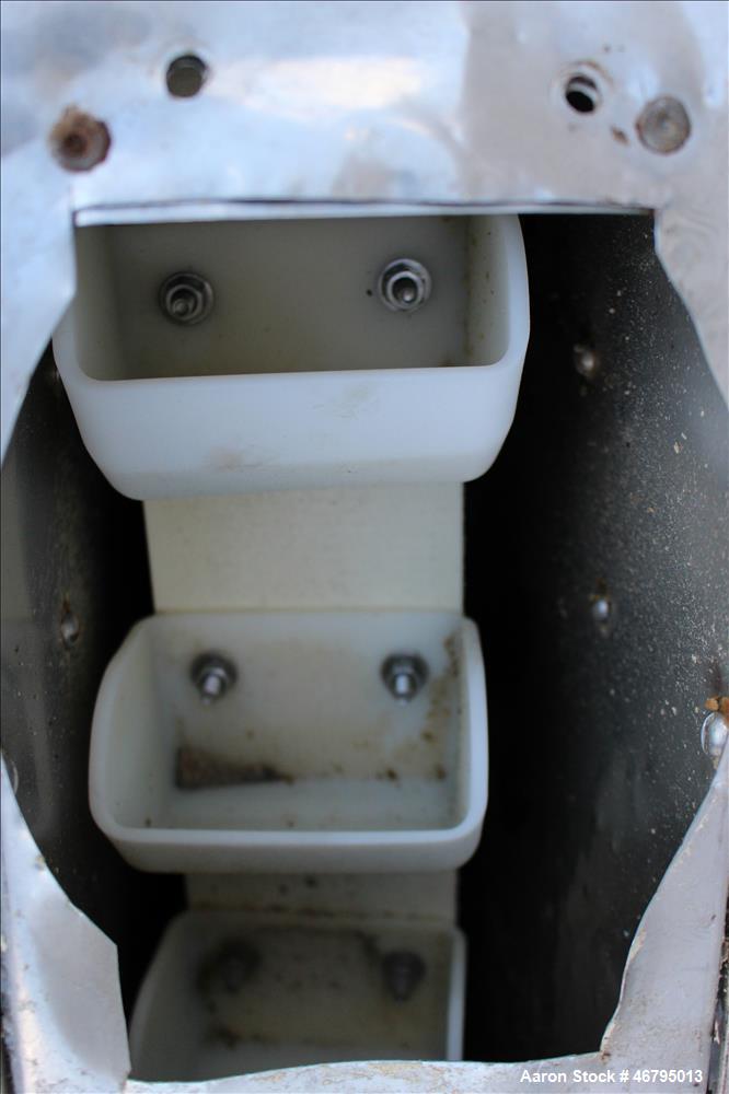 Used Bucket Elevator, Vertical. Approximate 12' Tall housing with 3-1/4" long x 4" wide x 3" deep poly buckets on 5-1/2" centers. Driven by a 0.5hp, 3/60/208-230/460 volt, 1725 rpm motor. 304 Stainle...