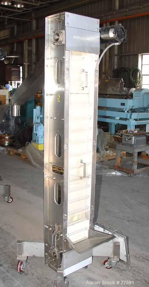 Used Kamflex Design Vertical Belt Conveyor. 10" Wide x 7'7.58" long rubber belt with 10" wide x 1-1/2" deep pockets, 43" discharge height with a 3-3/4" diameter discharge. Product density 30 lbs/cubi...