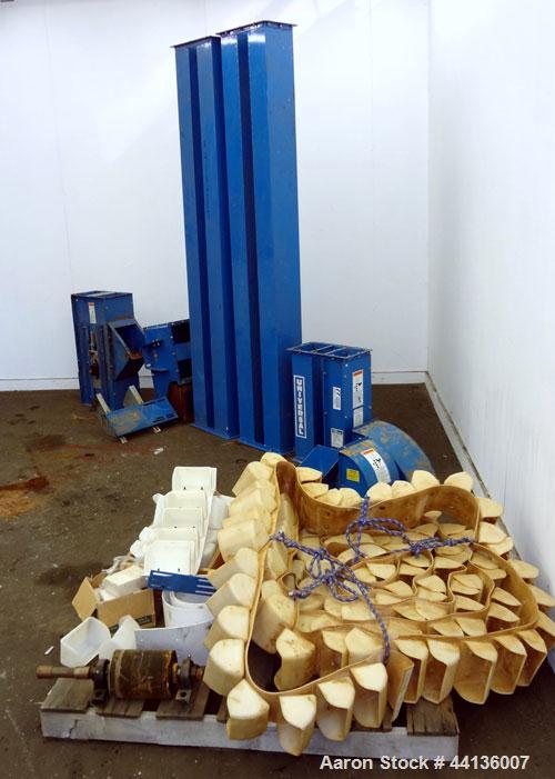 Used Universal Industries Vertical Bucket Elevator, Model C3-175, Carbon Steel. Capacity free flowing material 220 cubic feet per hour, approximately 27’ discharge height, 29’ overall height. Plastic...