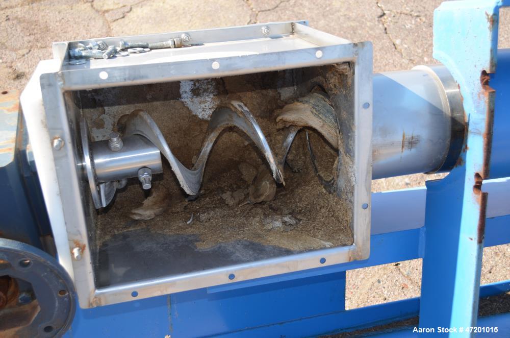 Used Hapman Flexable Tube Screw Conveyor, Stainless Steel. Approximate 6” diameter x 228 poly tube enclosed in a carbon steel tube. Approximate 6” diameter x 276” long helix type screw. No motor incl...