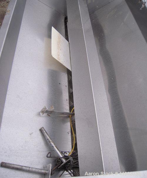 Used Dewatering Screw Conveyor, 304 stainless steel. 16" diameter x 106" long x 4 1/2" pitch screw, perforated bottom trough with 1/2" diameter holes. Top mounted hopper 62" wide x 105" long x 28" de...