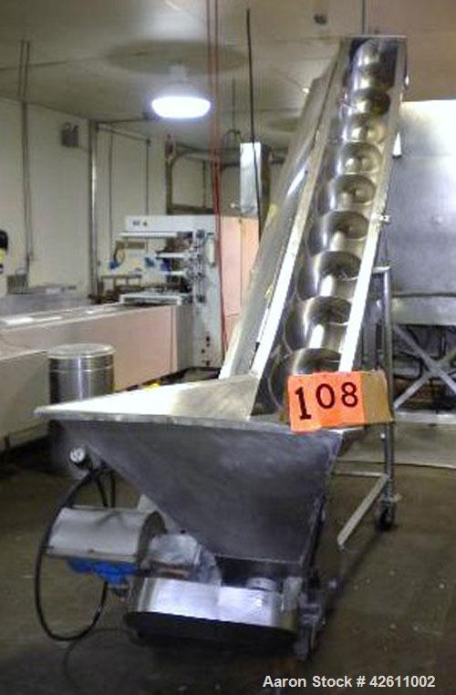 Used Inclined Screw Conveyor, Stainless Steel. 12" Diameter x 125" long x approximate 6" pitch. Trough 13" wide with hinged top cover section. Bottom feed hopper approximately 39" wide x 31" long x 2...
