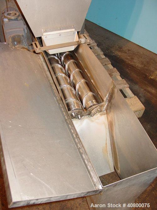 Used Vanmark Potato Feeder. (2) Approximate 3 1/2'' diameter x 42'' long side-by-side 316 stainless steel screws. Top feed with hopper, end bottom outlet. Driven by a 1 hp, 3/60/330/575 volt, 1700 rp...