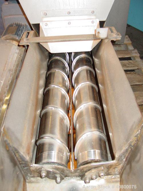 Used Vanmark Potato Feeder. (2) Approximate 3 1/2'' diameter x 42'' long side-by-side 316 stainless steel screws. Top feed with hopper, end bottom outlet. Driven by a 1 hp, 3/60/330/575 volt, 1700 rp...