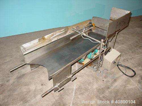 Used H Tech Vibratory Conveyor, stainless steel. 16'' wide x 42'' long x 3'' high sides vibrating pan. Syntron speed controller. Mounted on a carbon steel base.