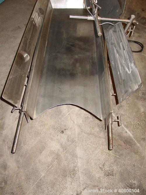 Used H Tech Vibratory Conveyor, stainless steel. 16'' wide x 42'' long x 3'' high sides vibrating pan. Syntron speed controller. Mounted on a carbon steel base.