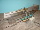 Used H Tech Vibratory Conveyor, stainless steel. 16'' wide x 42'' long x 3'' high sides vibrating pan. Syntron speed controller. Mounted on a carbon steel base.