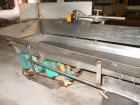 Used H Tech Vibratory Conveyor, stainless steel. 16'' wide x 42'' long x 3'' high sides vibrating pan. Syntron speed controller. Mounted on a carbon steel base.