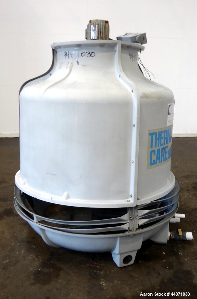 Used Thermal Care FT Series Cooling Tower, Fiberglass Construction. Cooling capacity 22 tons, nominal 66 gallons per minute. Includes an approximate 24" diameter top mounted fan, driven by a 1hp, 3/6...
