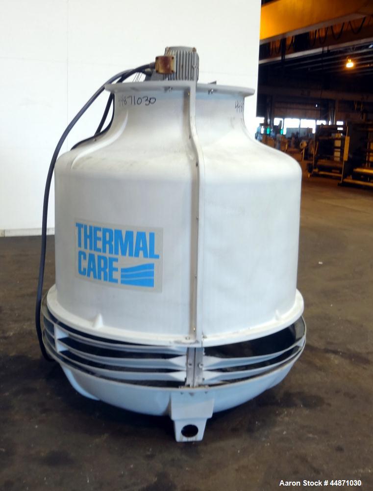 Used Thermal Care FT Series Cooling Tower, Fiberglass Construction. Cooling capacity 22 tons, nominal 66 gallons per minute. Includes an approximate 24" diameter top mounted fan, driven by a 1hp, 3/6...