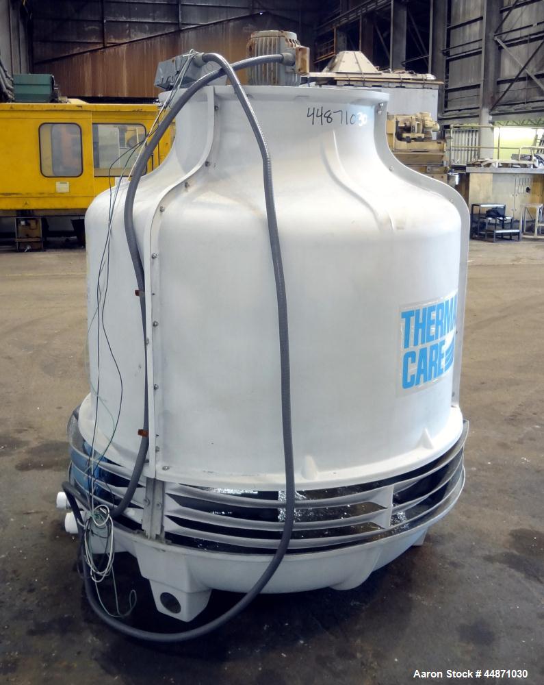 Used Thermal Care FT Series Cooling Tower, Fiberglass Construction. Cooling capacity 22 tons, nominal 66 gallons per minute. Includes an approximate 24" diameter top mounted fan, driven by a 1hp, 3/6...