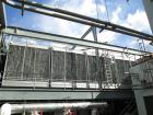 Used Marley Cooling Tower, Model NC8305BG, 450 ton, built 2006, hot and cold basins are stainless steel.