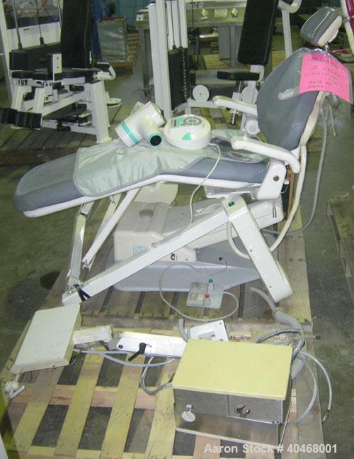 Used ADEC dental chair (gray) with unattached tray, ADEC light, and unattached Elitys X-ray machine with control panel.