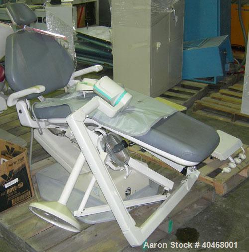 Used ADEC dental chair (gray) with unattached tray, ADEC light, and unattached Elitys X-ray machine with control panel.
